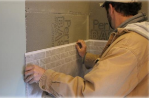 An installer works with Bella Core Grout-Free Vertical Surfaces