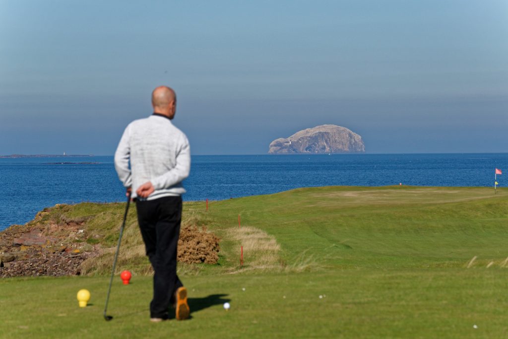 golfer enjoying costal view